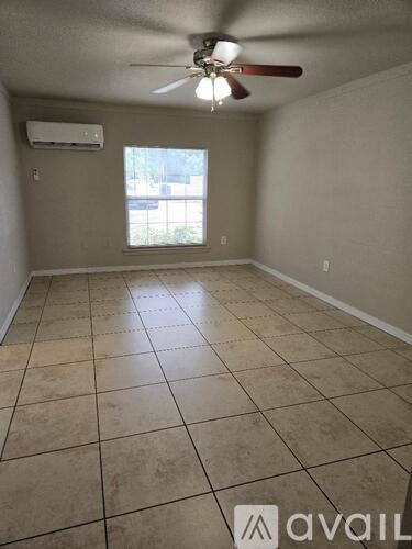 A room with a fan and tiled floor.