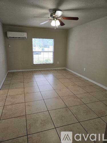 A room with a fan and tiled floor.