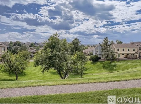 A suburban neighborhood with houses and trees.