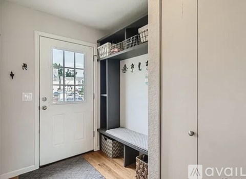 A white door is on the left and a white wall is on the right.