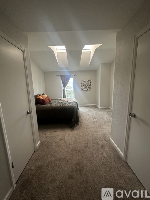 A bedroom with a bed and a window.