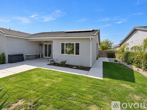 A house with a white exterior and a grey roof is for sale.