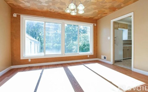 A room with a large window and a skylight.