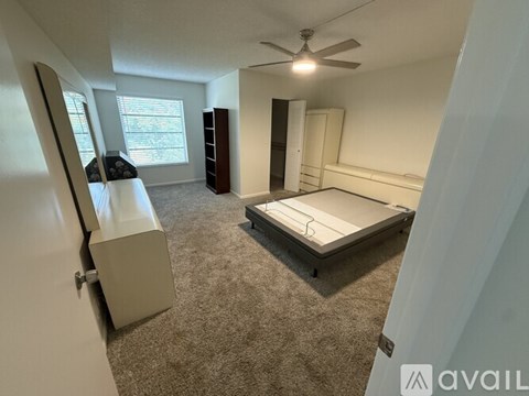 A bedroom with a bed, dresser, and mirror.