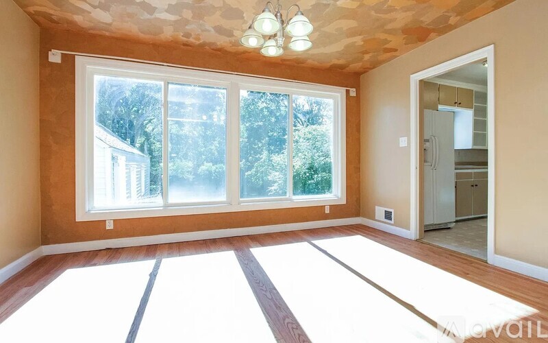 A room with a large window and a skylight.
