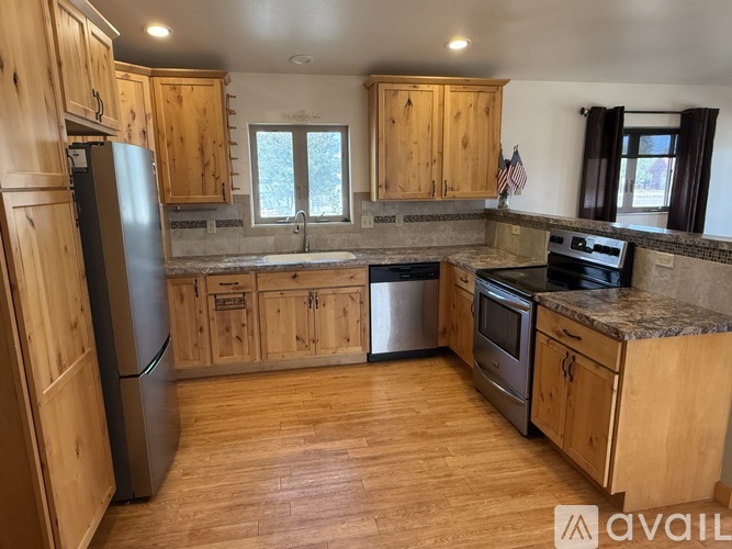 A kitchen with wooden cabinets and stainless steel appliances.