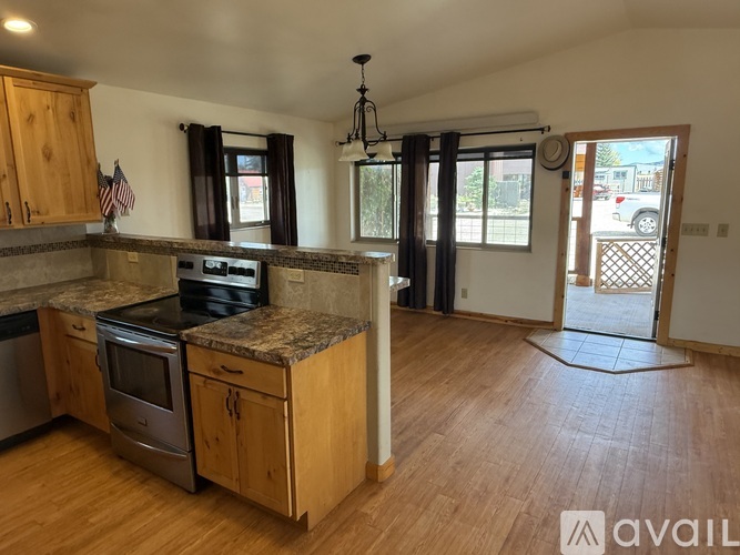 A kitchen with wooden cabinets and a granite countertop.
