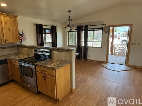 A kitchen with wooden cabinets and a granite countertop.