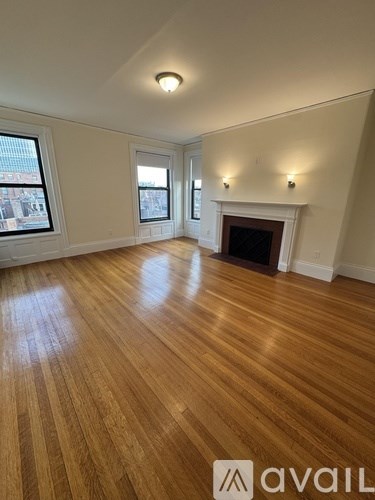 A room with wooden floors and a fireplace.