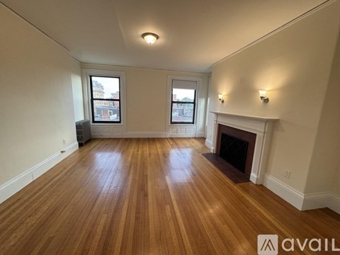 A room with wooden floors and a fireplace.