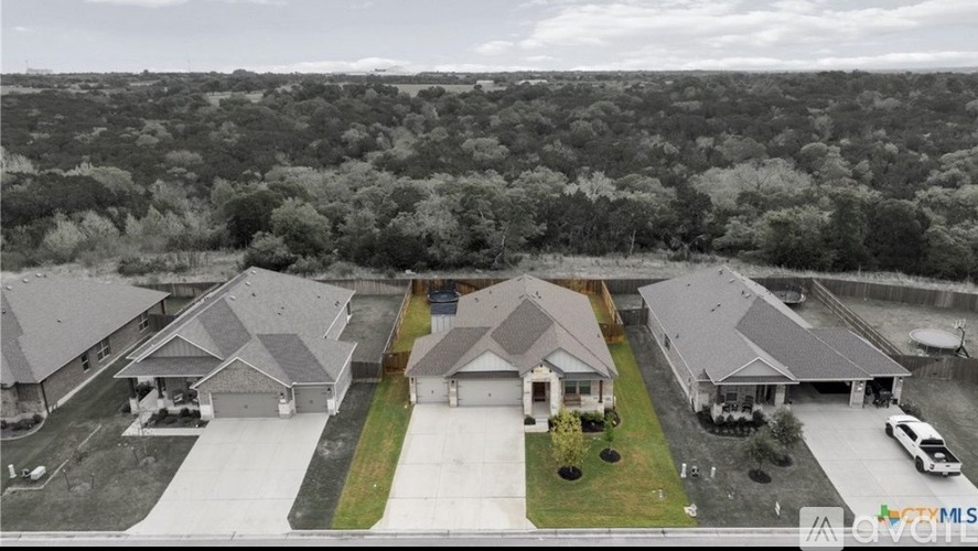A bird's eye view of a residential area with houses and cars.