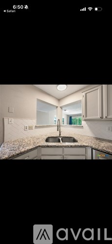 A kitchen with a sink and cabinets.