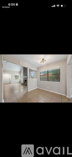 A room with a ceiling fan and a window.