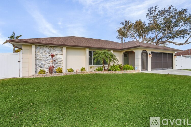 A house with a brown roof and a white garage door is for sale.