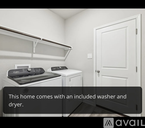 A white laundry room with a washer and dryer included.