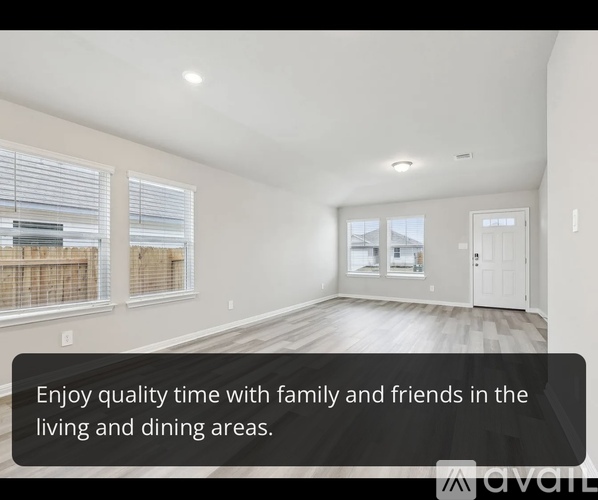 A living room with a large window and a door leading to a balcony.