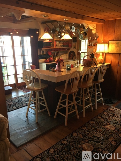 A kitchen with a table and chairs.
