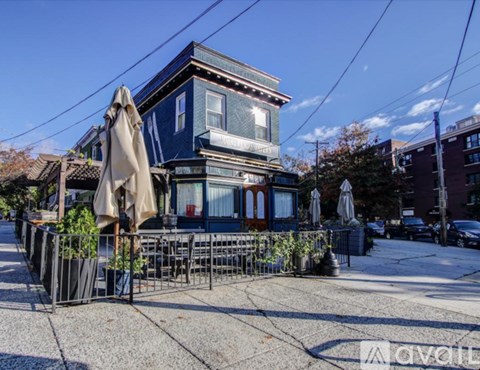 A blue building with a patio and umbrellas.