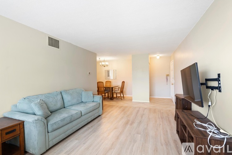 A living room with a grey couch and a television.