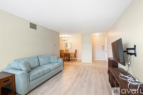 A living room with a grey couch and a television.