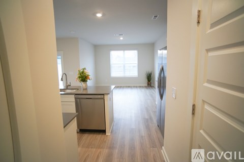 A kitchen with a dishwasher and a refrigerator.