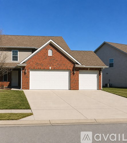 A house with a brick facade and two garages.