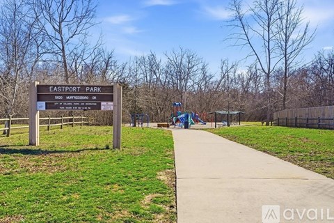A sign for Eastport Park stands in a grassy field.