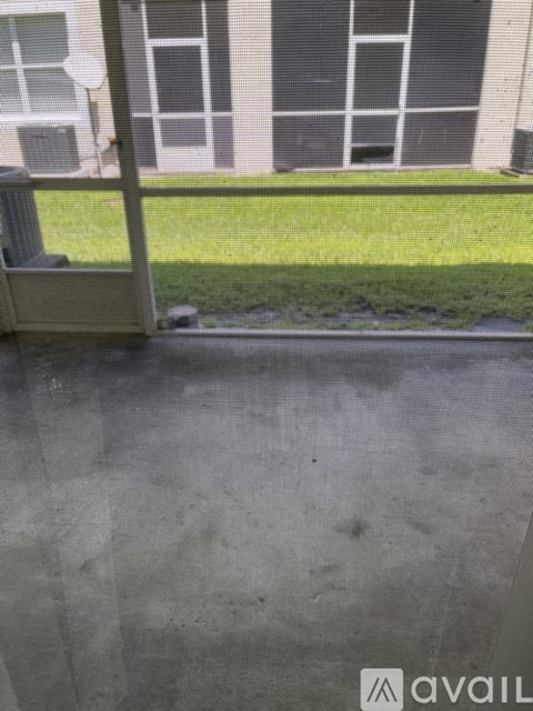 A view of a building through a mesh screen.