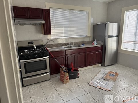 A kitchen with a stove, oven, and refrigerator.