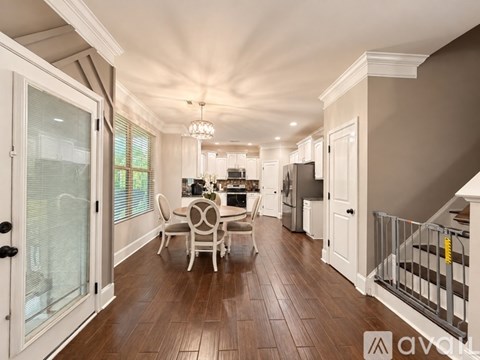 A well-lit, spacious dining area with a table set for four.