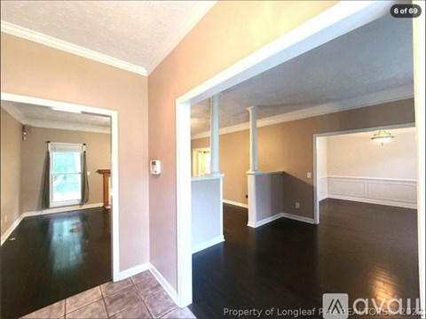A room with a window and a door leading to another room.