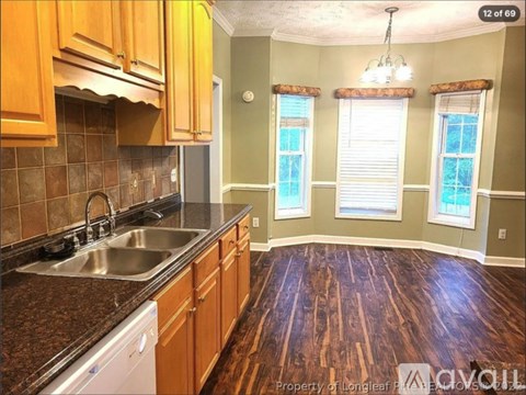 A kitchen with wooden cabinets and a stainless steel sink.