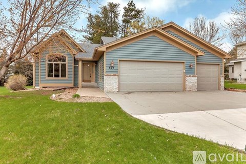 A house with a blue garage door is for sale.