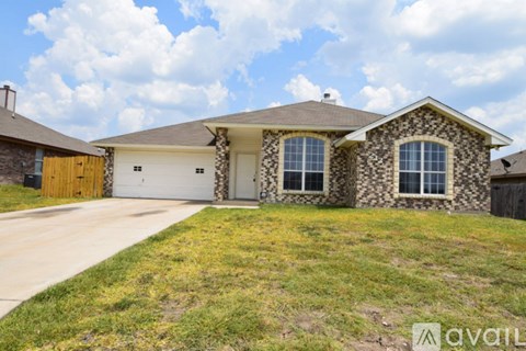 A house with a stone facade and a brown garage door.