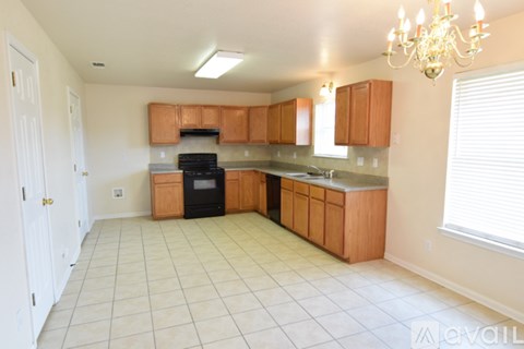 A kitchen with wooden cabinets and a black oven.