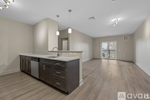 A spacious kitchen with dark wood cabinets and a large island.