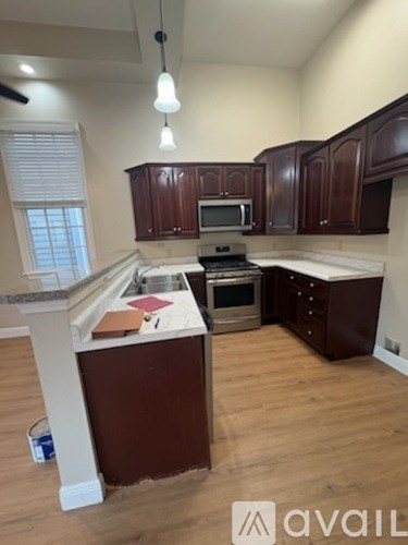 A kitchen with brown cabinets and a white island.