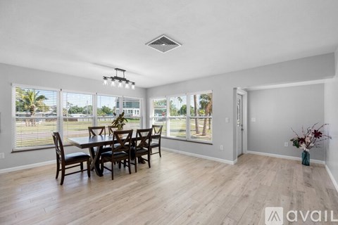 A dining room with a table set for six.