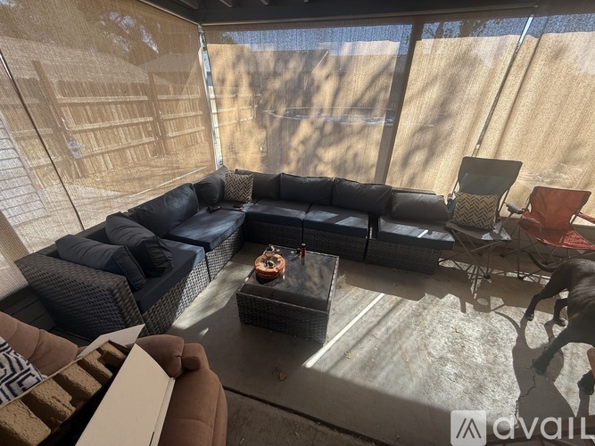 A living room with a black couch and a coffee table.