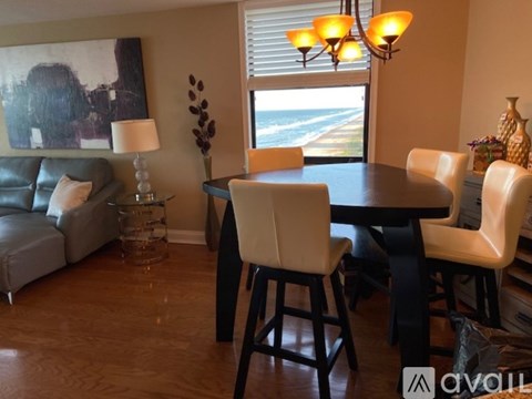 A dining room with a table and chairs.