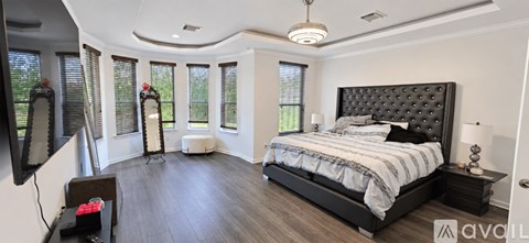 A bedroom with a large bed and a television.
