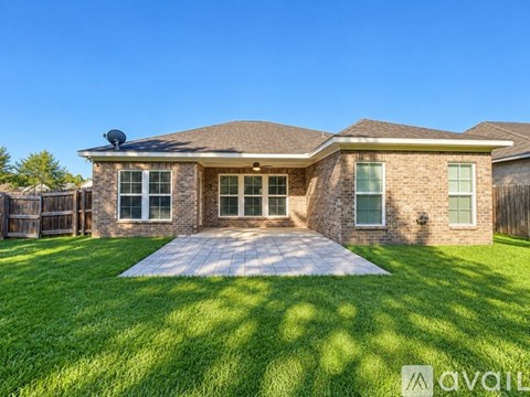 A house with a brick exterior and a covered patio.