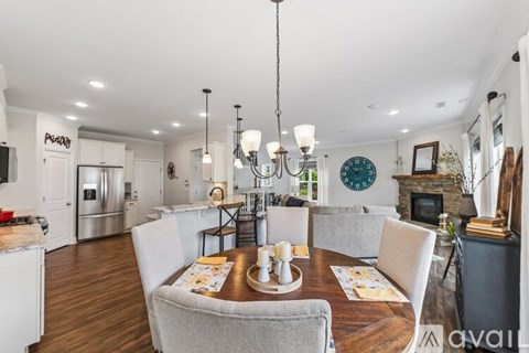 A modern kitchen with a dining table set for two.