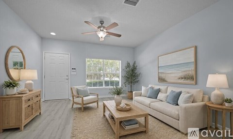 A living room with a couch, chair, and a painting on the wall.
