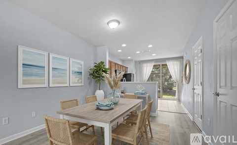 A dining room with a table set for four and a view of the outdoors.