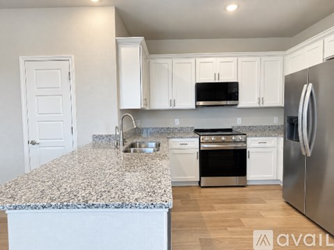 A kitchen with granite countertops and stainless steel appliances.