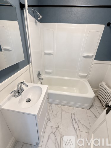 A white sink and bathtub in a bathroom.