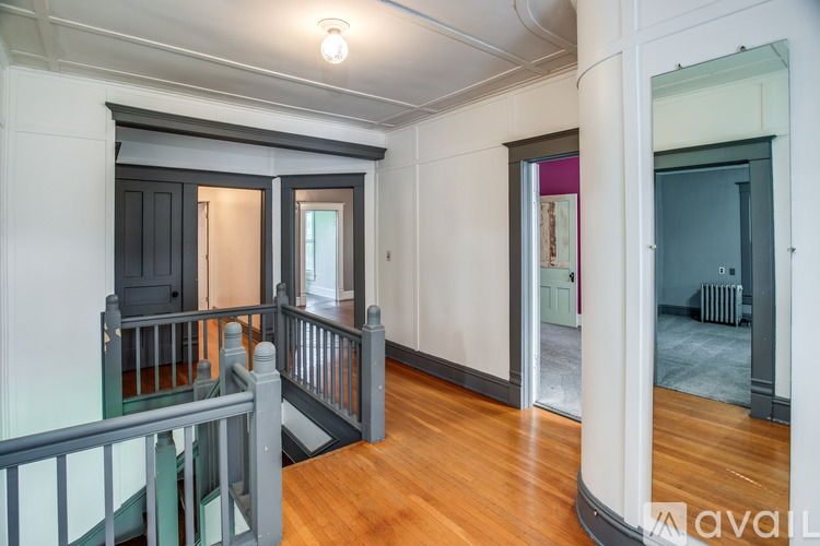 A large open space with a balcony and a view of a hallway.