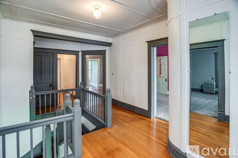 A large open space with a balcony and a view of a hallway.