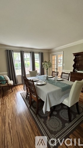 A dining room with a table set for four.